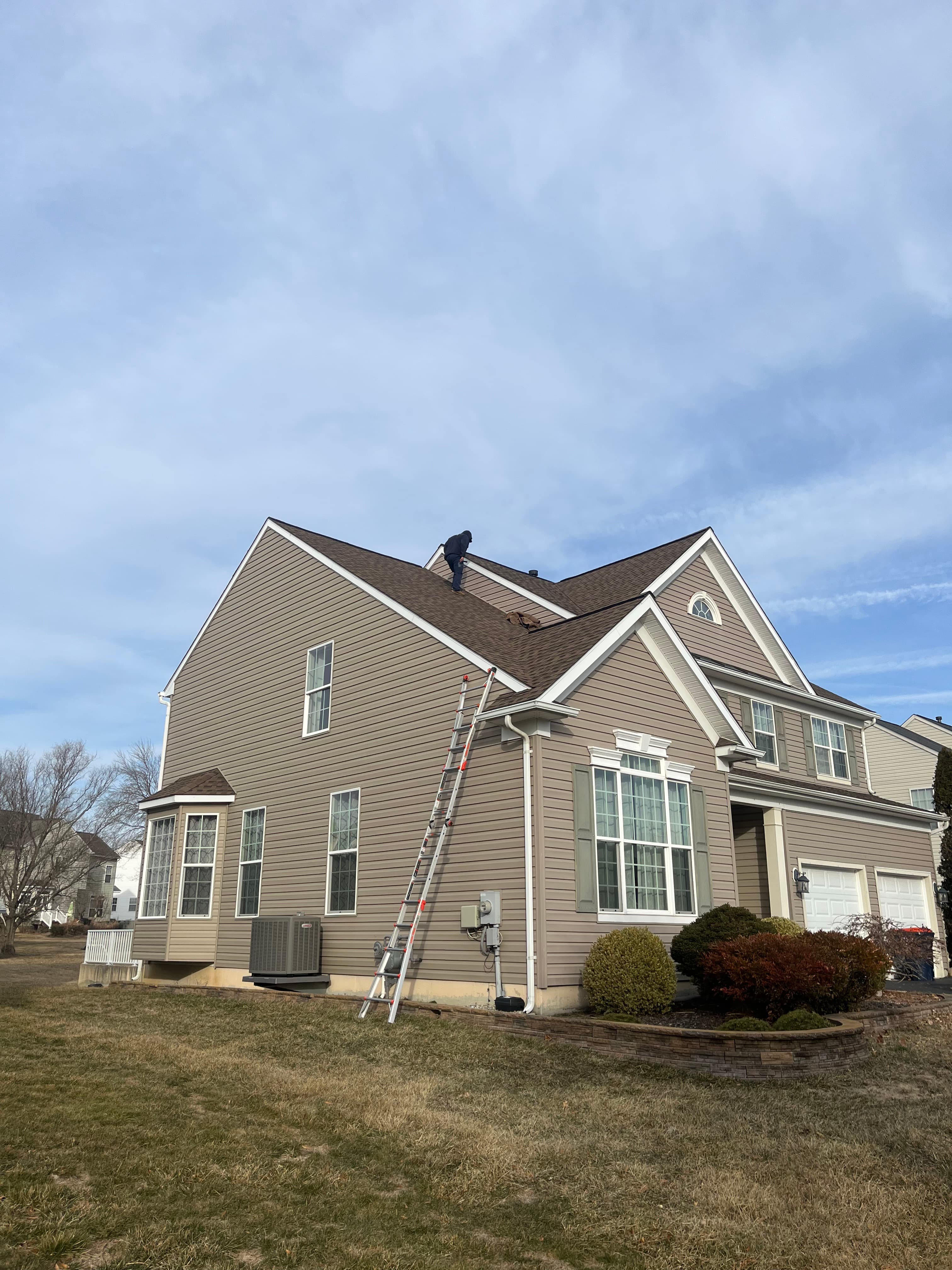 Alan Azocar performing a roof inspection on a Delaware home