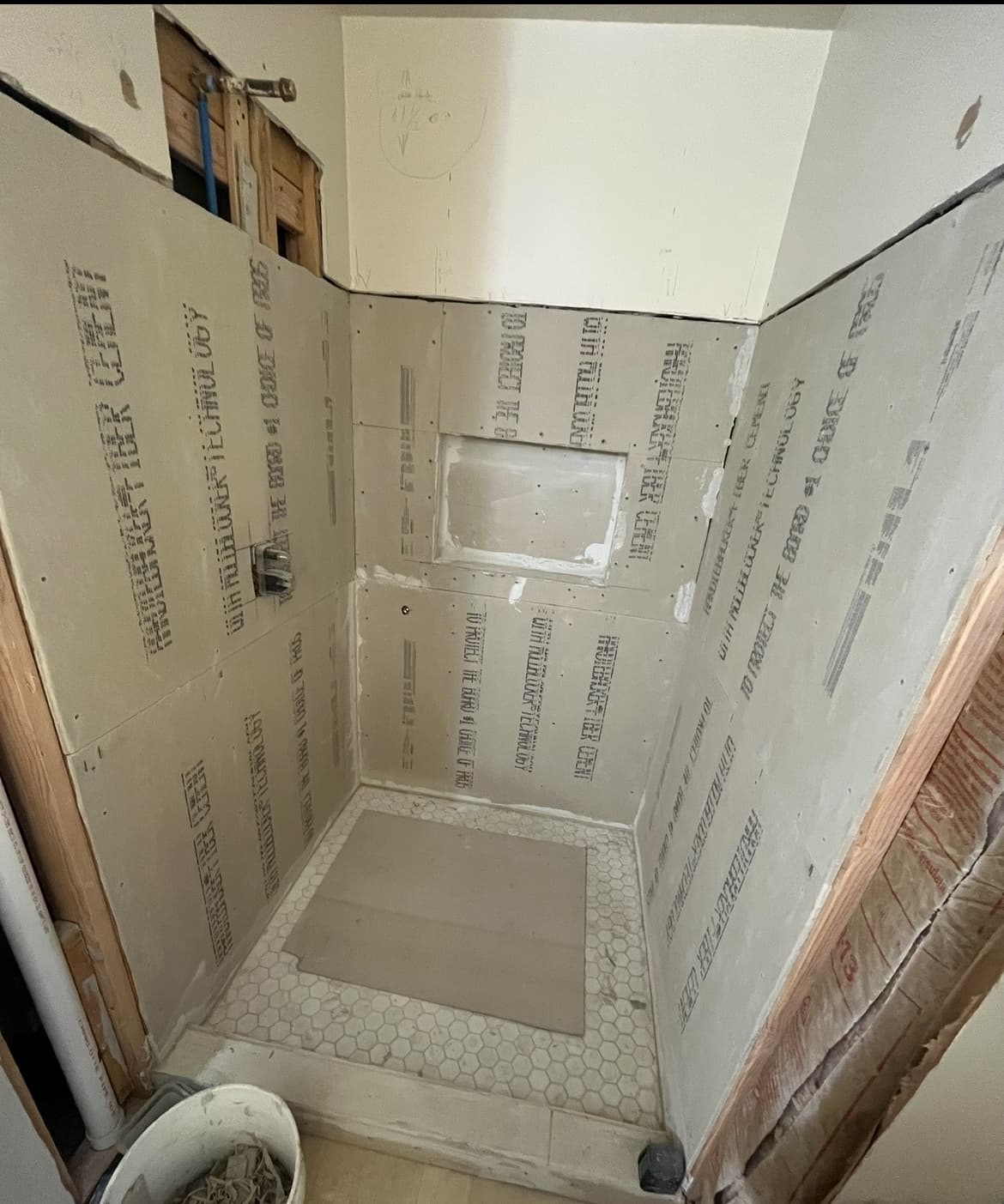 Shower stall with cement-board walls ready for tile installation