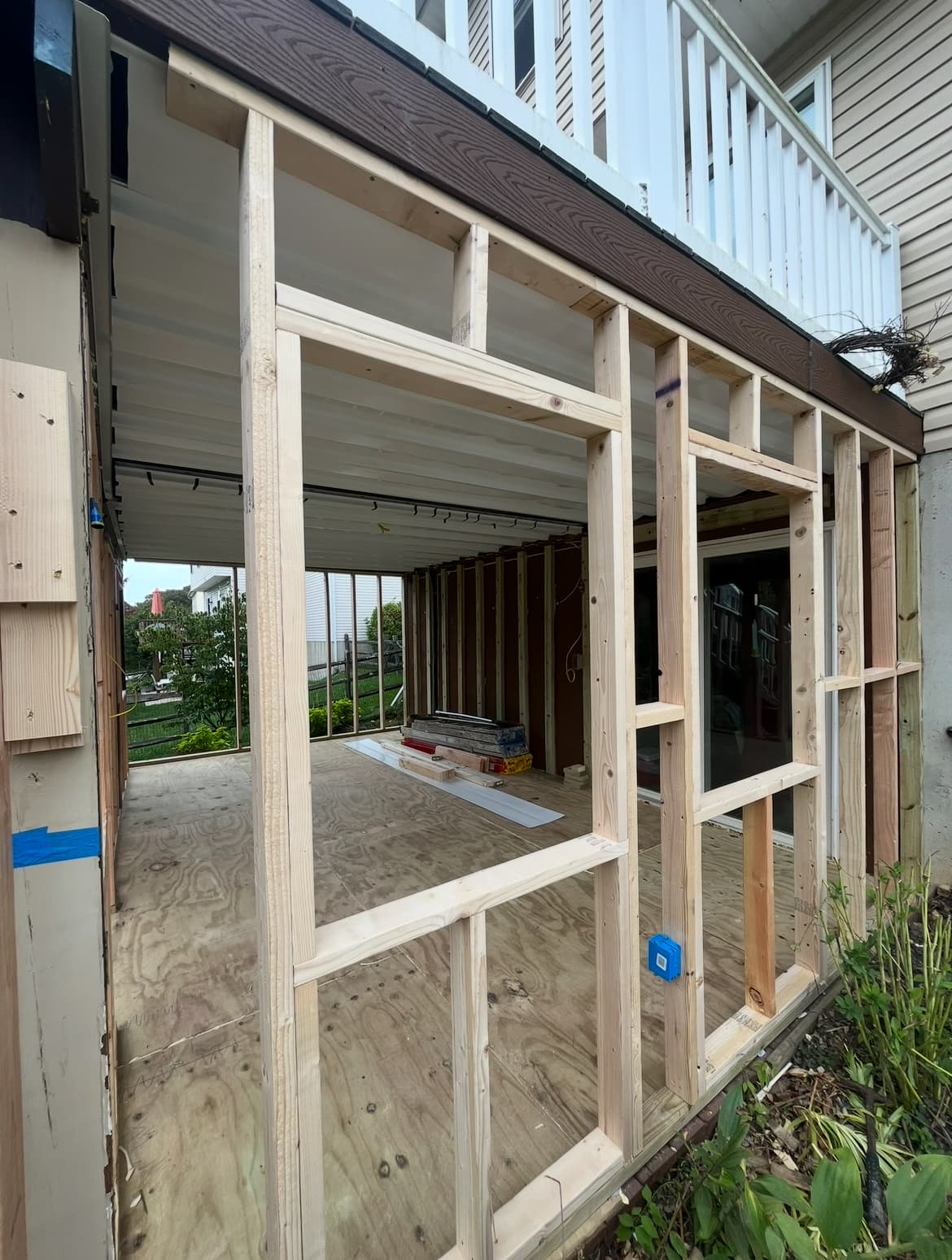 Exterior wood framing for a home addition with new wall studs in place