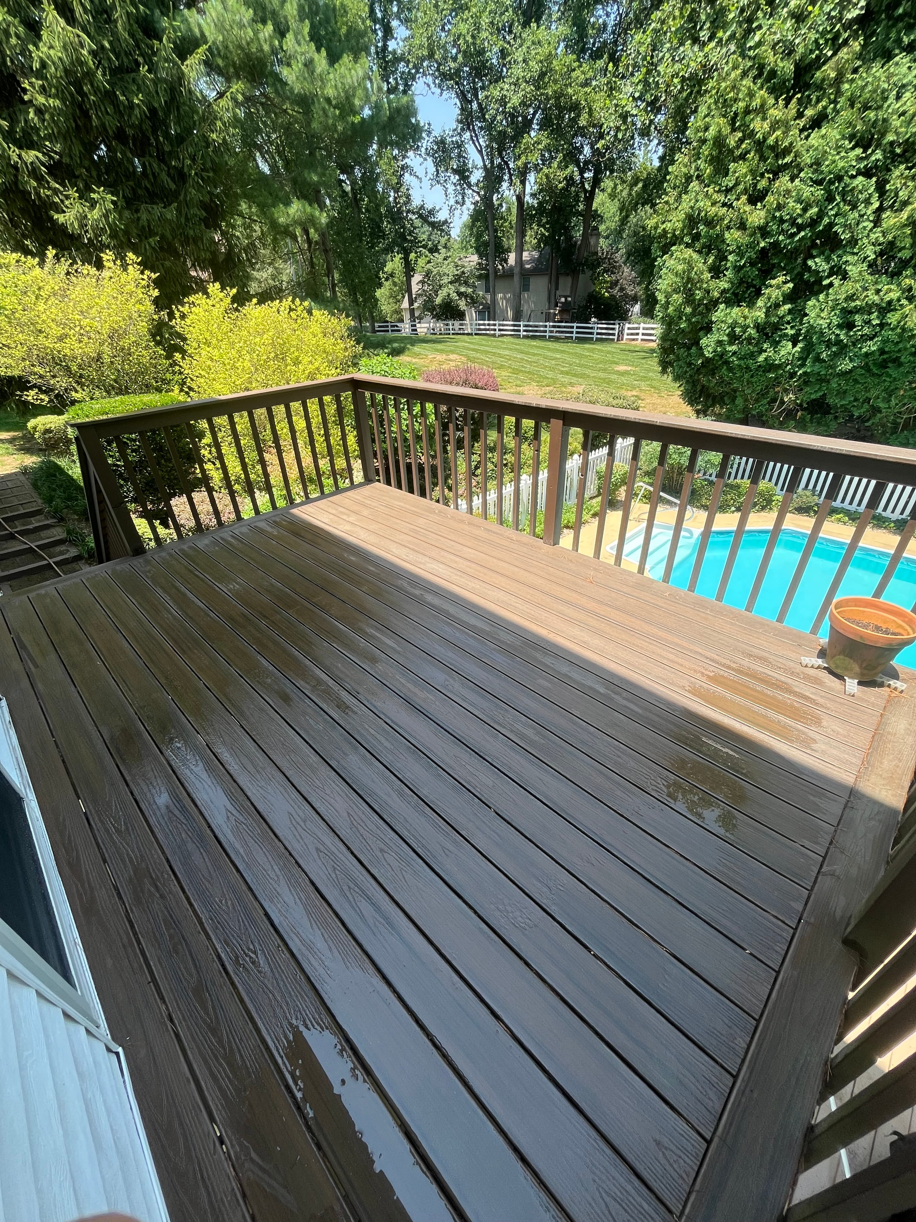 Restored backyard deck with composite decking overlooking a garden